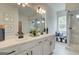 Bright bathroom featuring a double vanity, framed mirror, bench seat and glass shower with white and grey marble styled tile at 4484 Eastbrook Pl # 54B, Snellville, GA 30039
