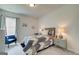 Calm bedroom with grey carpet, soft-blue patterned quilt, 2 bedside tables with lamps, and a blue accent chair at 4484 Eastbrook Pl # 54B, Snellville, GA 30039