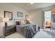 Cozy bedroom with two side tables and lamps, and a chair at 4484 Eastbrook Pl # 54B, Snellville, GA 30039