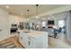 Open-concept kitchen and living area with stainless steel appliances and a cozy fireplace at 4484 Eastbrook Pl # 54B, Snellville, GA 30039