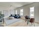 Living room featuring a large sectional sofa, ottaman, and picture windows at 4484 Eastbrook Pl # 54B, Snellville, GA 30039