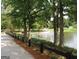 Peaceful view of a pond with a walking path and fountain in the background at 4484 Eastbrook Pl # 54B, Snellville, GA 30039