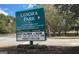 Roadside Lenora Park sign displaying park information and upcoming events at 4484 Eastbrook Pl # 54B, Snellville, GA 30039