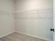 A walk-in closet with white walls and grey carpet, complete with shelving for storage and organization at 4484 Eastbrook Pl # 54B, Snellville, GA 30039