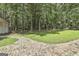 Lush backyard with a brick paver path leading through the green grass and mature trees at 205 Shadowood Ln, Peachtree City, GA 30269