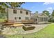 Expansive backyard with a wooden deck, brick patio, and stone fire pit perfect for entertaining at 205 Shadowood Ln, Peachtree City, GA 30269