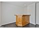 Close up of the bonus room bar area with wood finish and dark floors at 205 Shadowood Ln, Peachtree City, GA 30269