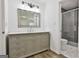Updated bathroom features a gray vanity with marble top and a glass enclosed tiled shower at 205 Shadowood Ln, Peachtree City, GA 30269