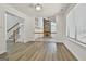 Open dining room with bright white walls and light-colored wood flooring, with views to living room at 205 Shadowood Ln, Peachtree City, GA 30269