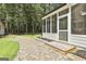 Charming screened porch with a brick paver patio and lush green backyard at 205 Shadowood Ln, Peachtree City, GA 30269