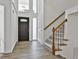 Bright foyer featuring hardwood floors, a staircase, and a stylish front door creating a welcoming entrance at 205 Shadowood Ln, Peachtree City, GA 30269