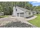Spacious two-car garage with a concrete driveway and tidy landscaping adds functionality and convenience at 205 Shadowood Ln, Peachtree City, GA 30269