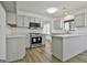 Bright kitchen featuring gray cabinets, quartz countertops and stainless steel appliances with adjacent eating area at 205 Shadowood Ln, Peachtree City, GA 30269