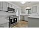 Bright kitchen featuring gray cabinets, quartz countertops and stainless steel appliances at 205 Shadowood Ln, Peachtree City, GA 30269