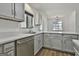 Bright kitchen featuring gray cabinets, quartz countertops and stainless steel appliances at 205 Shadowood Ln, Peachtree City, GA 30269