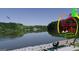 Scenic Peachtree City lake view with a bench, and wooded scenery at 205 Shadowood Ln, Peachtree City, GA 30269