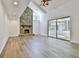 Bright living room featuring a stone fireplace, vaulted ceiling and large glass sliding door to outdoor space at 205 Shadowood Ln, Peachtree City, GA 30269