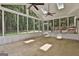Sunroom surrounded by windows, natural light, ceiling fans and concrete floors at 205 Shadowood Ln, Peachtree City, GA 30269