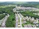 Expansive aerial view of a densely populated neighborhood surrounded by verdant trees at 302 Aspen Valley Ln, Dallas, GA 30157