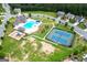 Aerial view of community pool, playground, and tennis court with ample green space at 302 Aspen Valley Ln, Dallas, GA 30157