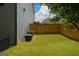 Grassy backyard with a wooden fence and mature tree at 302 Aspen Valley Ln, Dallas, GA 30157
