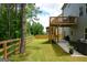 Fenced backyard with deck, patio, and lush greenery surrounding the perimeter at 302 Aspen Valley Ln, Dallas, GA 30157