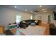 A brightly lit basement with hardwood floors, sectional seating, and a mounted TV at 302 Aspen Valley Ln, Dallas, GA 30157