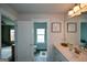 Bathroom showcasing double vanity and a door leading to a private toilet room at 302 Aspen Valley Ln, Dallas, GA 30157