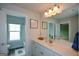 Bright bathroom with a white vanity, framed mirror, and a separate toilet and shower room at 302 Aspen Valley Ln, Dallas, GA 30157