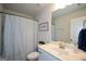 Bathroom featuring single vanity, decorative shower curtain, and framed wall art at 302 Aspen Valley Ln, Dallas, GA 30157