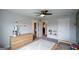 Neutral bedroom with modern dresser, cozy rug and a car-themed gallery wall art at 302 Aspen Valley Ln, Dallas, GA 30157