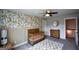 Neutral Bedroom features stylish floral wallpaper, wood crib and a modern dresser for baby supplies at 302 Aspen Valley Ln, Dallas, GA 30157