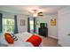 Bright bedroom featuring large windows, ceiling fan, and dark wood dresser with television at 302 Aspen Valley Ln, Dallas, GA 30157