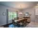 Inviting dining room with natural light, a stylish chandelier, and a view of the outdoors at 302 Aspen Valley Ln, Dallas, GA 30157