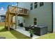 Back exterior featuring deck with stairs, lower patio, and fenced backyard at 302 Aspen Valley Ln, Dallas, GA 30157