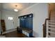 Bright foyer with a custom mudroom bench, dark hardwood floors, and stairs leading to the upper level at 302 Aspen Valley Ln, Dallas, GA 30157