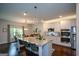 Well-appointed kitchen with stainless steel appliances and a large island for Gathering and entertaining at 302 Aspen Valley Ln, Dallas, GA 30157