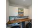 Functional laundry area with stylish wood countertops and overhead cabinets for storage at 302 Aspen Valley Ln, Dallas, GA 30157