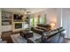 Cozy living room with a brick fireplace, built-in shelves, and comfortable seating at 302 Aspen Valley Ln, Dallas, GA 30157