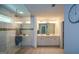 Bright main bathroom with a glass-enclosed shower, dual sink vanity, tile floor and a linen closet at 302 Aspen Valley Ln, Dallas, GA 30157