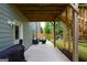 Covered patio features an outdoor seating area, swing, and access to backyard at 302 Aspen Valley Ln, Dallas, GA 30157