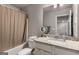 Well-lit bathroom with granite countertops, a shower curtain, and a decorative mirror at 2829 Wild Laurel Ct, Norcross, GA 30071