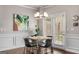 Dining area with modern chandelier, wainscoting, and access to a patio at 2829 Wild Laurel Ct, Norcross, GA 30071