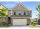 Charming townhome featuring a two-car garage and traditional architectural details at 2829 Wild Laurel Ct, Norcross, GA 30071