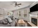 Living room featuring hardwood floors, fireplace, ceiling fan, and comfortable gray couch at 2829 Wild Laurel Ct, Norcross, GA 30071