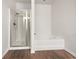 Bathroom featuring a separate shower stall, soaking tub, and sleek, modern finishes at 36 Crescent Chase, Dallas, GA 30157