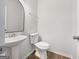 Bathroom features a pedestal sink and modern toilet at 36 Crescent Chase, Dallas, GA 30157