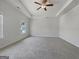Bright bedroom features neutral carpet, a window, and ceiling fan at 36 Crescent Chase, Dallas, GA 30157