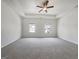 Tranquil primary bedroom featuring a tray ceiling, plush carpet, and ample natural light at 36 Crescent Chase, Dallas, GA 30157