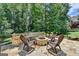 Outdoor patio with a stone fire pit, seating, and access to a large wooden deck at 5245 Cottage Farm Rd, Johns Creek, GA 30022